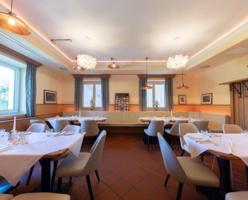 © Adrian Almasan | www.adrianalmasan.com Gemütlicher Speiseraum im Lokal von Das Chadim, eingerichtet für bis zu 120 Personen, mit eleganten Tischen, modernen Leuchten und Blick ins Grüne.